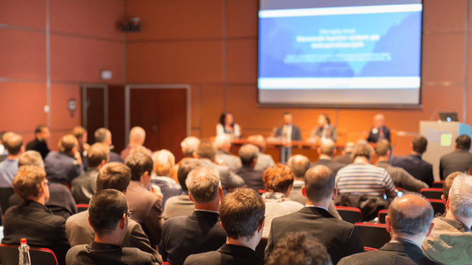 Attending conferences helps refine your research interests by providing opportunities to engage with experts, exchange ideas, and stay updated on emerging trends in your field.