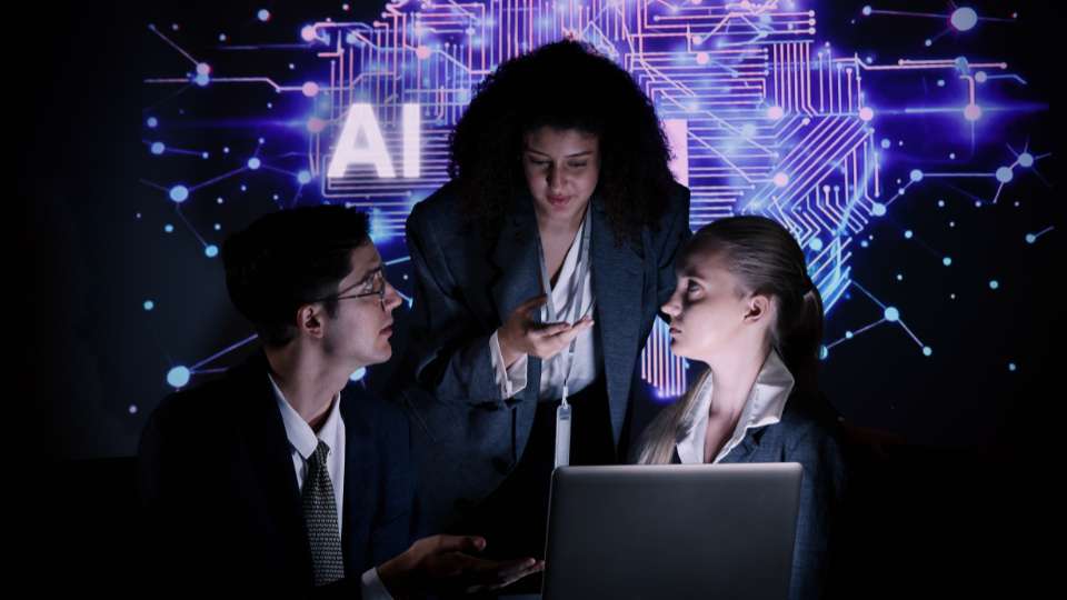 A futuristic digital illustration of a glowing blue wireframe hand reaching out to touch a sleek, 3D "AI" icon floating on a dark background. The "AI" letters are bold and metallic, set against a glowing square panel. This image serves as a visual metaphor for the synergy between human intellect and machine learning. It illustrates the text's message that by using AI hacks, researchers can bridge the gap between confusion and discovery, effectively leveraging technology as a personal assistant to uncover hidden research gaps and transform the speed of academic study.