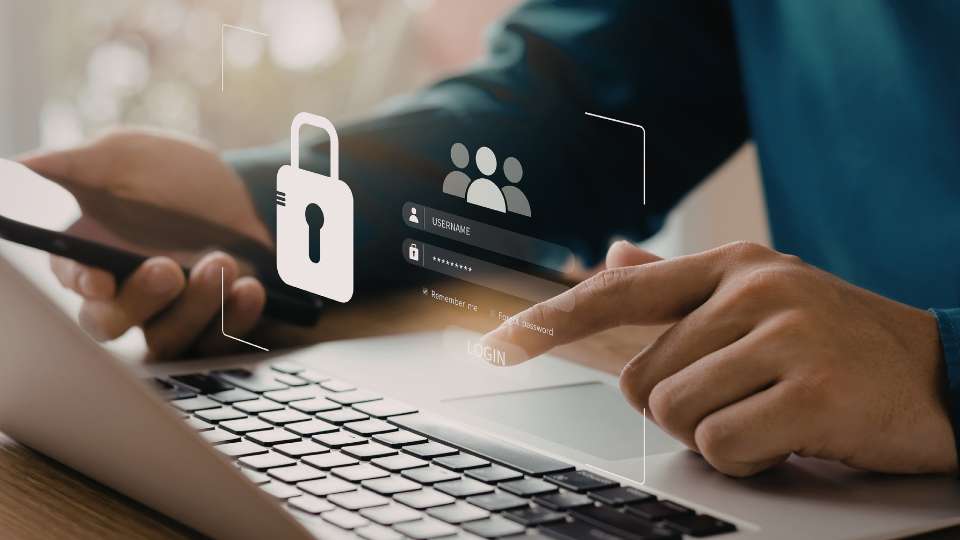 A conceptual image showing a person's hand using a laptop with a digital overlay of a security login interface and a large padlock icon. The person is holding a smartphone in their other hand, suggesting multi-device synchronization. The digital graphic features a "Username" and "Password" field alongside a group icon, symbolizing the collaborative yet secure nature of defining data storage and access rights within a research team to protect shared intellectual property.