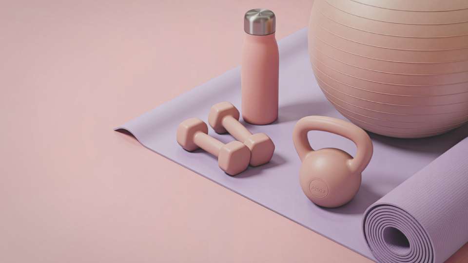 Pink fitness gear including a mat, dumbbells, and kettlebell, symbolizing portable home workout equipment for busy researchers traveling during an academic career.